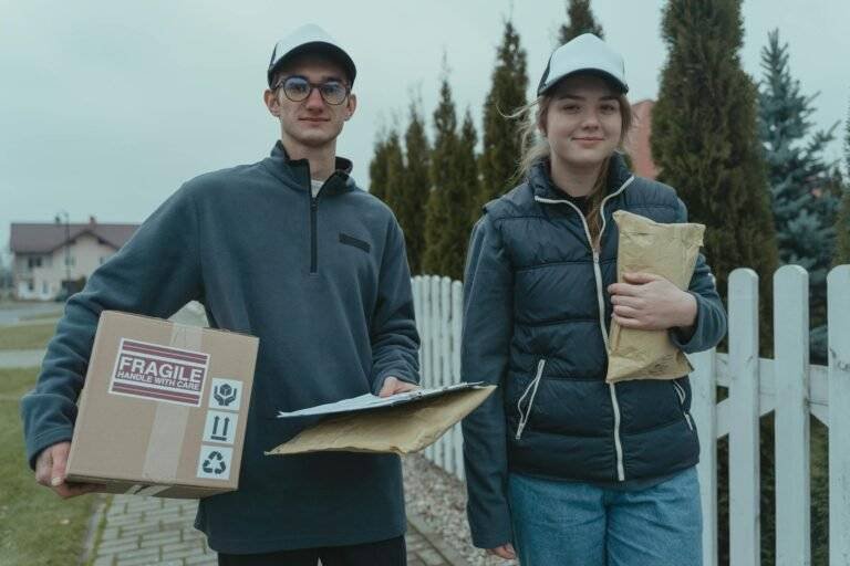 a man and a woman holding delivery packages