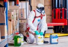 person wearing white suit holding white container