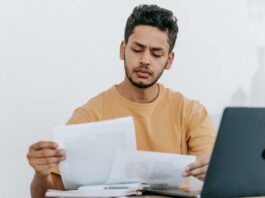 man looking through documents at workplace