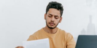 man looking through documents at workplace