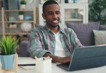 smiling man working on laptop