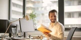 photo of man holding a book