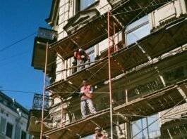 men on brown scaffolding
