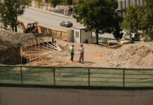 construction site with engineers discussing plans