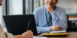 woman filling job application form in office with boss
