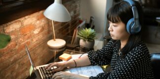 woman in black and white polka dot long sleeve shirt using macbook air