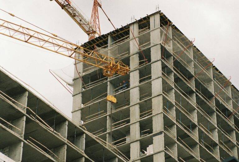 crane near concrete buidling under construction