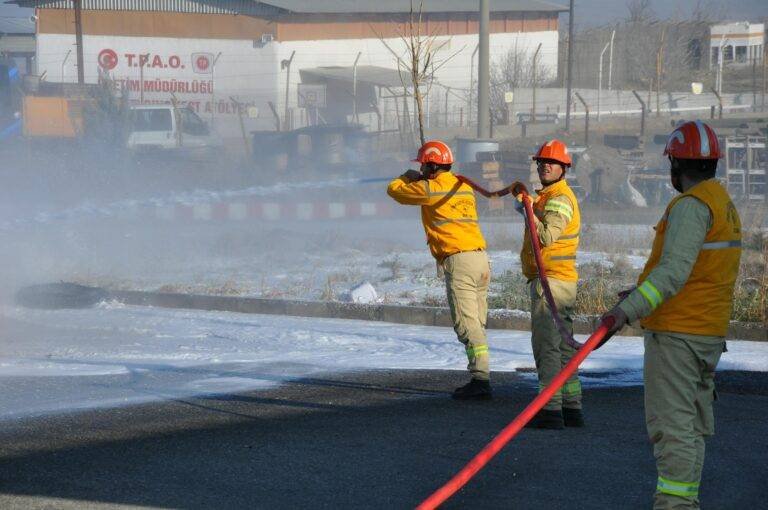 firefighters extinguishing fire on street