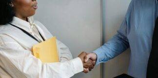 diverse coworkers shaking hands after meeting
