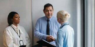 cheerful multiethnic colleagues having deal in office