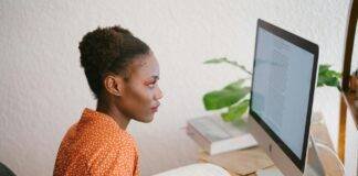 photo of woman looking on computer