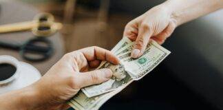 hands holding us dollar bills