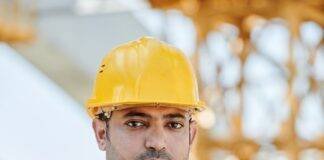 man in blue uniform and yellow hardhat