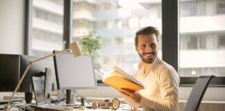 photo of man holding a book