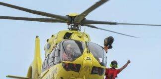 a man in a yellow helmet is flying in the air
