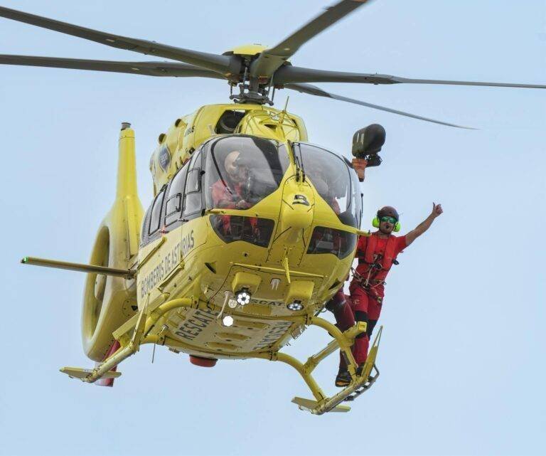 a man in a yellow helmet is flying in the air