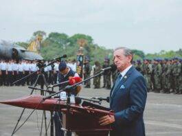 man in suit giving speech