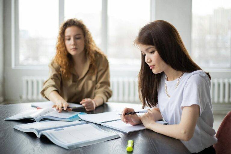 focused diverse women studying together
