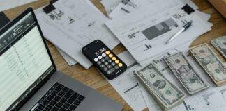 banknotes and calculator on table