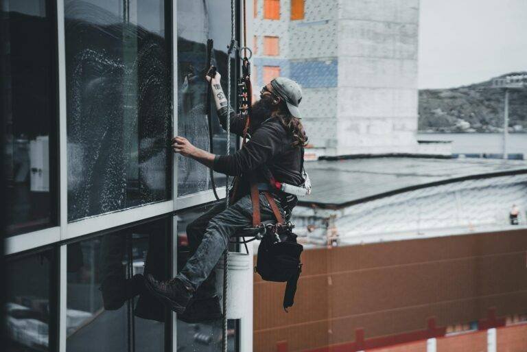 man doing high rise window cleaning