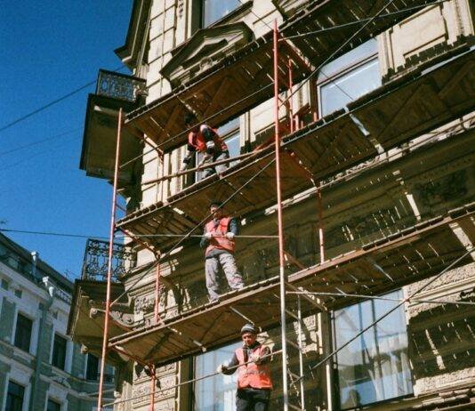 men on brown scaffolding