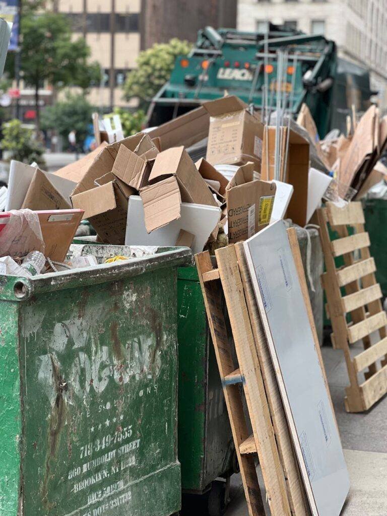 a pile of cardboard boxes sitting in a trash can