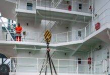 maritime workers loading supplies on ship deck