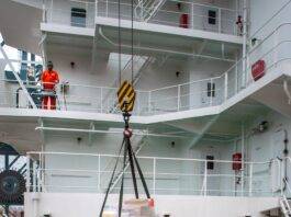 maritime workers loading supplies on ship deck