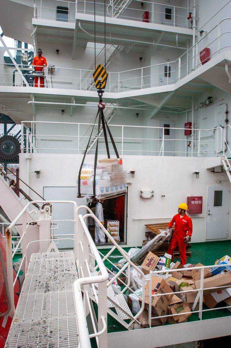 maritime workers loading supplies on ship deck