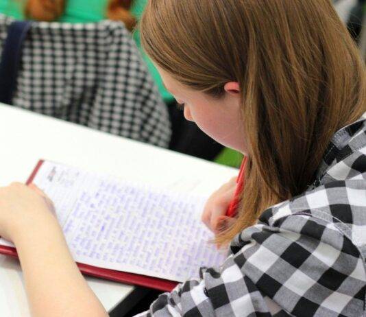 woman writing on paper