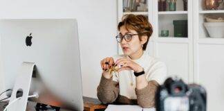 confident elegant lady in eyeglasses hosting webinar