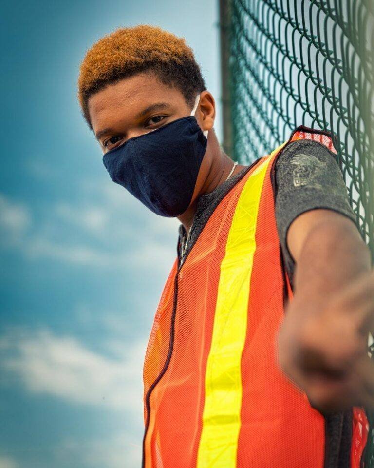 a man wearing face mask and reflectorized vest