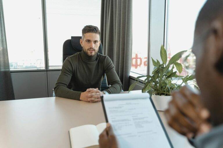 man in black long sleeve shirt sitting on chair