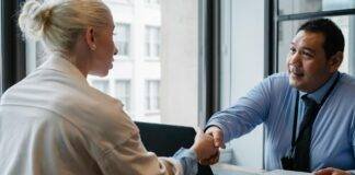 ethnic businessman shaking hand of applicant in office