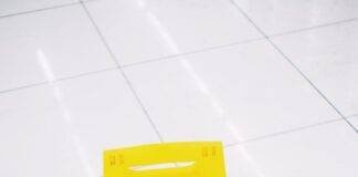 yellow warning sign placed on floor