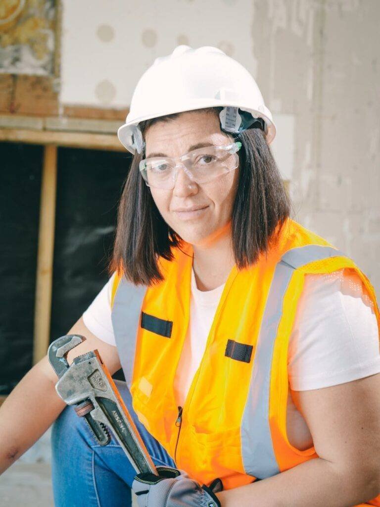 handywoman holding a plumbers wrench