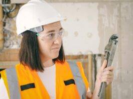 handywoman holding a plumbers wrench