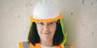 woman in reflective vest and white hardhat
