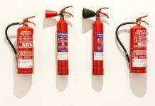 assorted fire extinguishers on white surface
