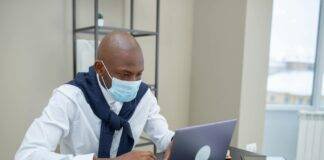 a man in white long sleeves using a laptop