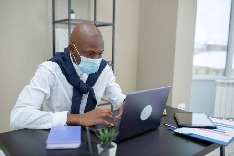a man in white long sleeves using a laptop