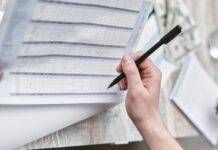 close up shot of a person holding a pen