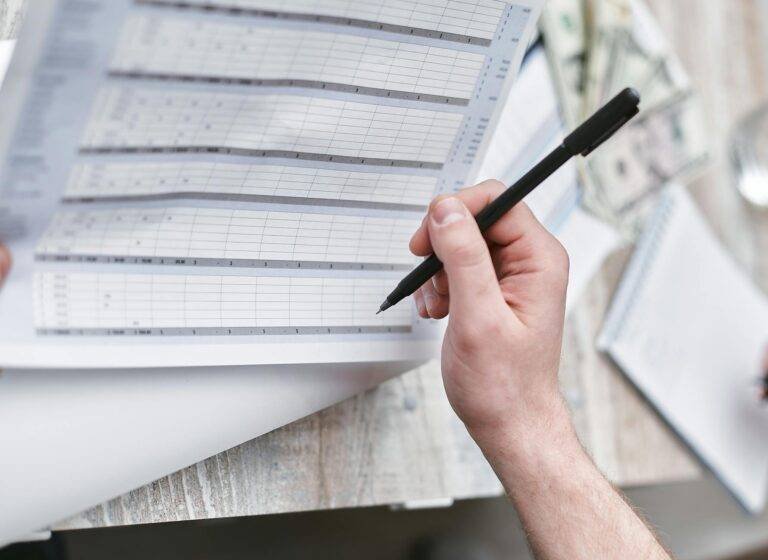 close up shot of a person holding a pen