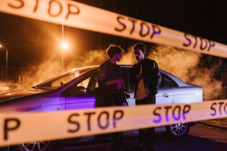men standing beside white car